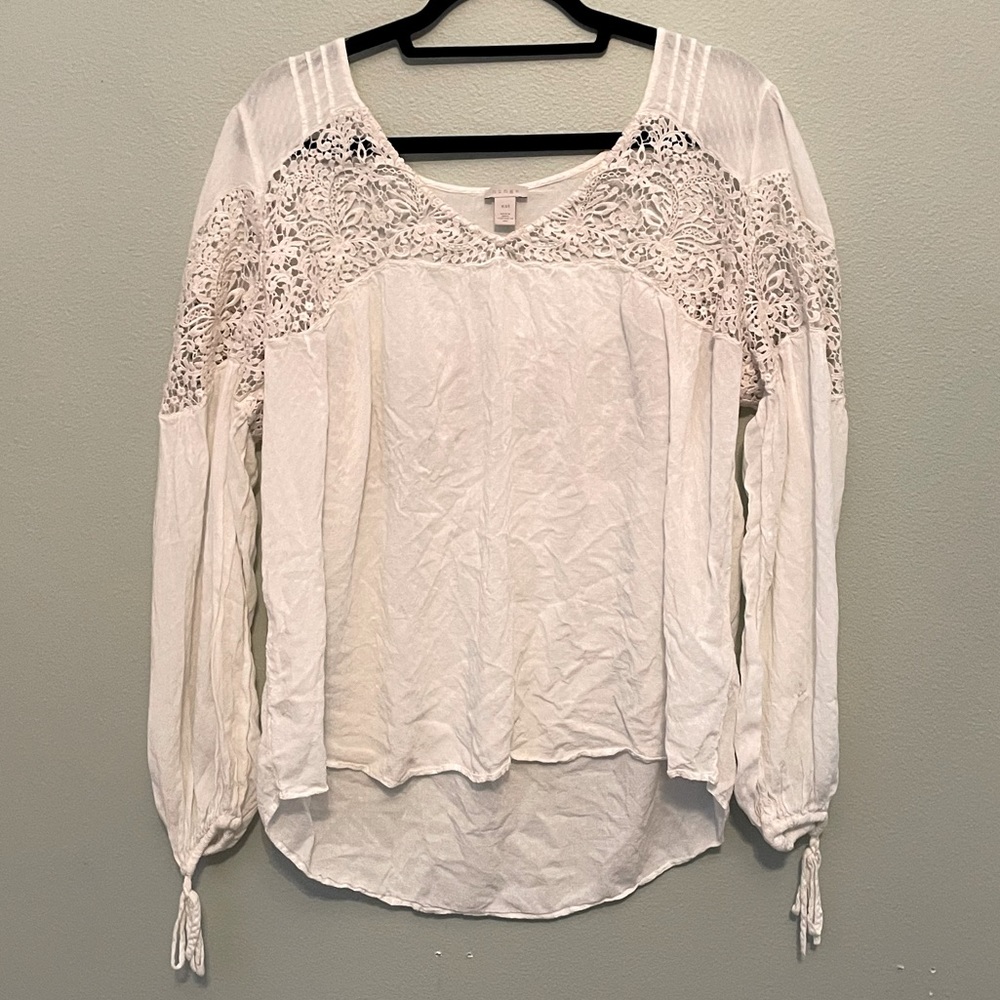 White flowy blouse, lace cutouts, puff sleeve, tie wrist, v neck